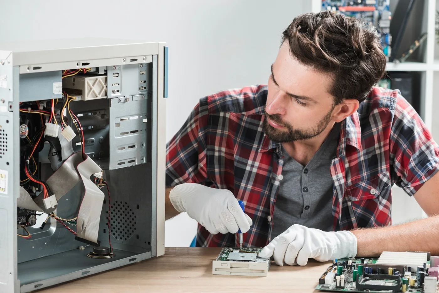 Computer repair technician servicing desktop hardware